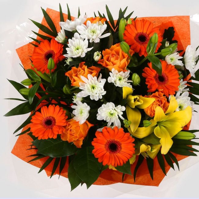 Orange Burst BouquetOrange Burst Bouquet, This lovely selection of flowers is the perfect gift for any occasion. Orange Germini, Orange Roses & Yellow Lillies with White Spray flowers and other assorted flowers are beautifully presented. Beautifully wrapp