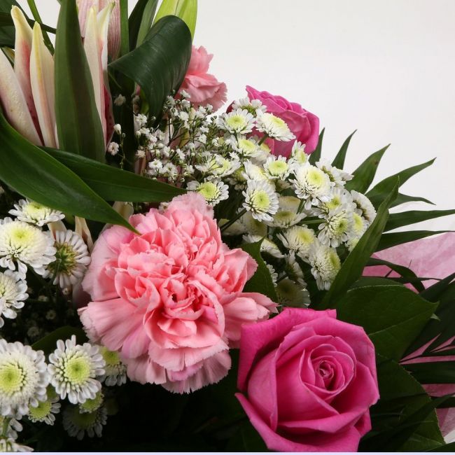 Strawberry Sundae BouquetStrawberry Sundae Bouquet, An endearing classic Bouquet, Lilies in soft pinks, White Santini, with Pink Roses, large exquisite headed Dianthus, Pink Roses are complemented by delicate Gypsophila, luxurious sophisticated hand-tied