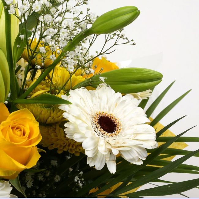 Lemon & White BouquetLemon & White Bouquet, We know how much you like this bouquet! lovely fresh Yellow Roses contrast against the white Gypsophila, with palm leaves, White Germini and Chrysanthemums, lovely bunch of flowers. Beautifully wrapped and tied