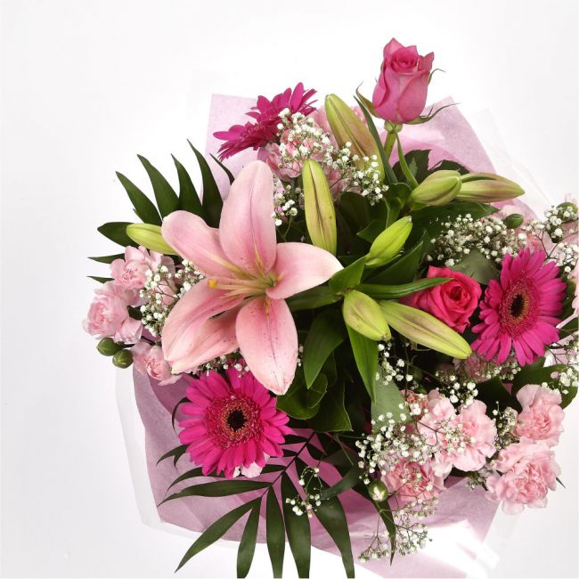 Pink Sienna BouquetThis lovely selection of flowers is the perfect gift for any occasion.Pink Germini, Pink Roses & Pink Spray with Palm Leaf and other assorted flowers are beautifully presented. Beautifully wrapped and tied with ribbon before being deliv