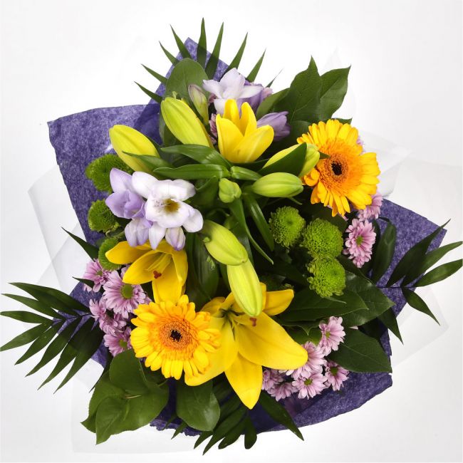 Scented Lilly & Freesias BouquetGreat Value with Scented Freesias Bouquet, Yellow Gerberas with foliage. A beautiful selection of , Yellow Lillies with Scented Freesias,are presented in a coordinating collar of tissue paper & cellophane with ribbon. The p
