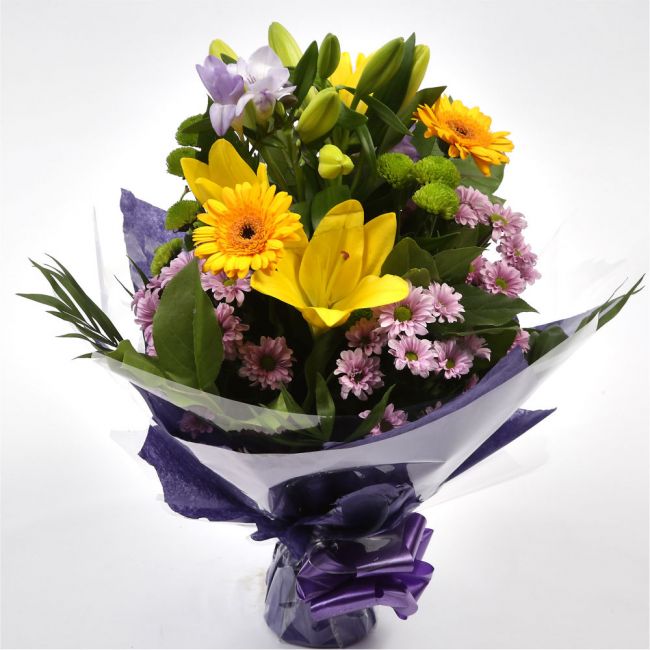 Scented Lilly & Freesias BouquetGreat Value with Scented Freesias Bouquet, Yellow Gerberas with foliage. A beautiful selection of , Yellow Lillies with Scented Freesias,are presented in a coordinating collar of tissue paper & cellophane with ribbon. The p