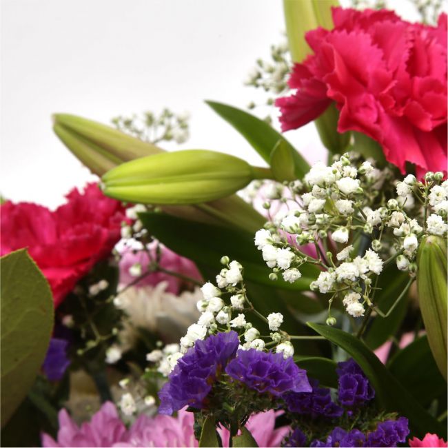 Stunning Pink Cerise BouquetThis Sweet Pink bouquet features matching Pink Chrysanthemums, Pink Cerise Carnations, purple Statice and Gypsophila, punctuated with leaves Pink Lillies, expertly created by our florists. Beautifully wrapped and tied with ribb
