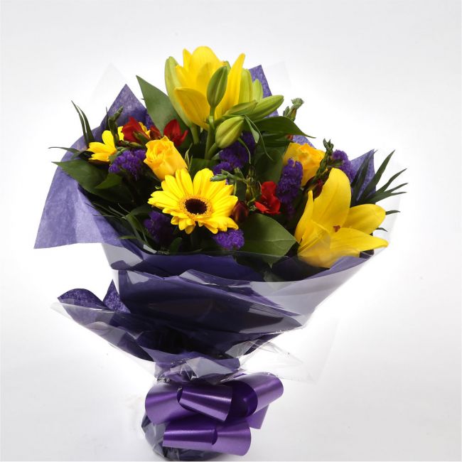 Yellow Blush BouquetAn alluring hand-tied bouquet featuring Oriental Lilies, Gerberas, , White Roses, Anastasia in an array of pinks with striking Bloom Chrysanthemums and Pink Gypsophila. A truly glamorous gift for any special occasion. Expertly created