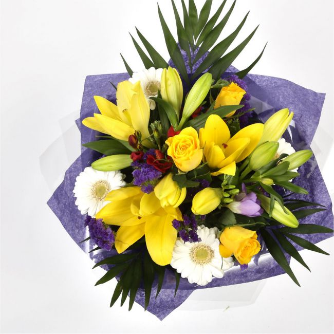 Delightful Flowers BouquetA Delightful Bouquet filled with flowers in Yellow and Purple shades. Including large-headed Roses, Lilies, Carnations, Freesias, a modern yet truly enchanting gift. Beautifully wrapped and tied with ribbon before being delivered