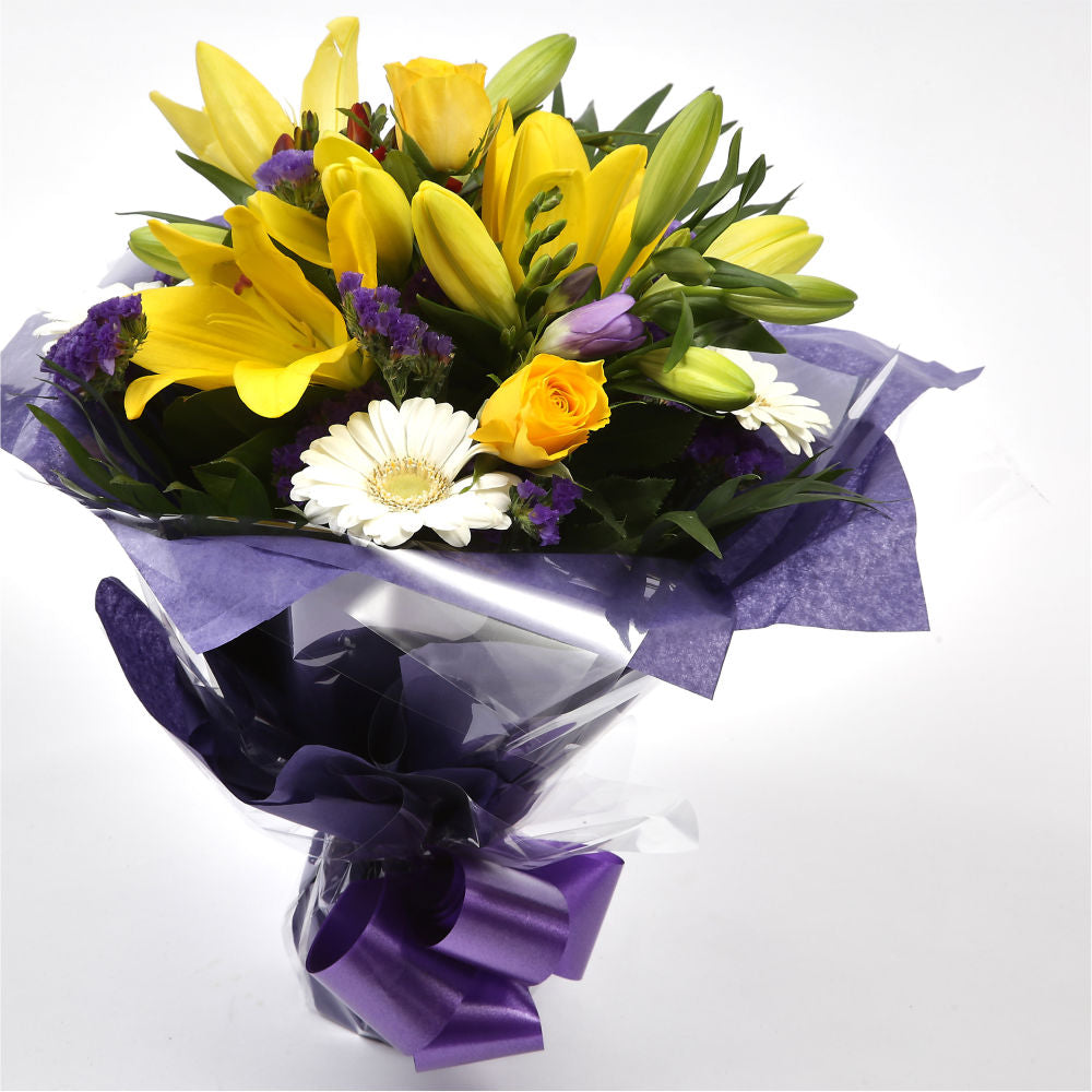 Delightful Flowers BouquetA Delightful Bouquet filled with flowers in Yellow and Purple shades. Including large-headed Roses, Lilies, Carnations, Freesias, a modern yet truly enchanting gift. Beautifully wrapped and tied with ribbon before being delivered