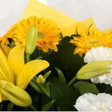 Golden Sunshine Flowers BouquetGolden Sunshine Bouquet, This lovely selection of flowers is the perfect gift for any occasion. White Dianthus, Yellow Roses & Yellow Lillies with assorted foliage are beautifully presented. Beautifully wrapped and tied with