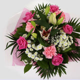 Strawberry Sundae BouquetStrawberry Sundae Bouquet, An endearing classic Bouquet, Lilies in soft pinks, White Santini, with Pink Roses, large exquisite headed Dianthus, Pink Roses are complemented by delicate Gypsophila, luxurious sophisticated hand-tied