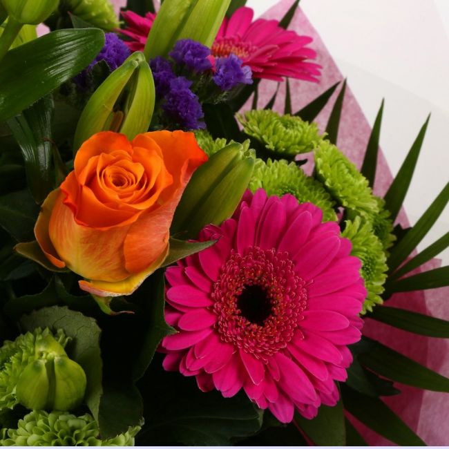 Melody Bright BouquetMelody Bright Bouquet, This bouquet of flowers is a sweet selection Cerise Germini, Oranage Roses, Yellow Lillies with Shamrock Chrysanthemums and Foliage.this bouquet is full of pretty shades . It's absolutely perfect. Beautifully wr