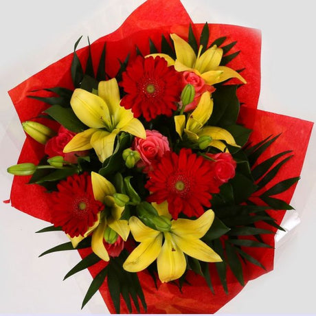 Emporium Flowers BouquetEmporium Bouquet Gerberas, Roses, Oriental Lilies and Palm foliage are expertly arranged to create this dramatic design. This stunning gift is the ultimate gift to create an impression. Beautifully wrapped and tied with ribbon befo
