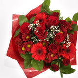 Lavish Red BouquetAdd a hint of paradise to someone's life with this vibrant Lavish Red Rose arrangement. Evoking lush Palm leaves,Gypsophila,Red Spray Dianthus, A beautiful and timeless classic. Beautifully wrapped and tied with ribbon before being deliv
