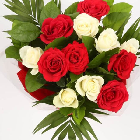 Thank You Balloon & 12 Red & White RosesThis Beautiful Bouquet, carefully selected flowers with foliage are expertly arranged to create this dramatic design. This stunning gift is the ultimate gift to create an impression. Beautifully wrapped and tied wit