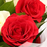 Love You Balloon & 12 Red & White RosesThis Beautiful Bouquet, carefully selected flowers with foliage are expertly arranged to create this dramatic design. This stunning gift is the ultimate gift to create an impression. Beautifully wrapped and tied with