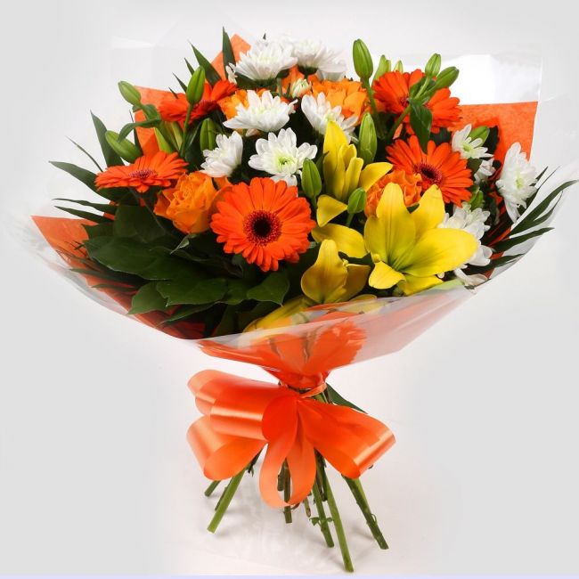Orange Burst BouquetOrange Burst Bouquet, This lovely selection of flowers is the perfect gift for any occasion. Orange Germini, Orange Roses & Yellow Lillies with White Spray flowers and other assorted flowers are beautifully presented. Beautifully wrapp