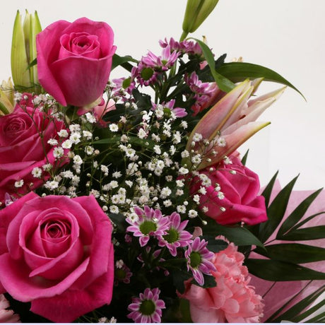 Birthday Balloon & Pink Crystal FlowersHappy Birthday Balloon & Beautiful Pink Crystal Bouquet, Pink Roses and Lillies with Gypsophila, Pink Dianthus, Pink Santini flowers and foliage, wrapped with matching ribbon. Beautifully wrapped and tied with ribbon