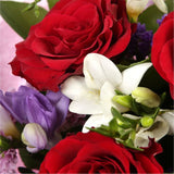 Pastel Beautiful BouquetAn eye-catching hand-tied bouquet including Freesias, Statice, Spray Chrysanthemums and large-headed Red Roses complemented by white & purple Freesias. finished with a cerise ribbon, this vivid selection of flowers will create a st