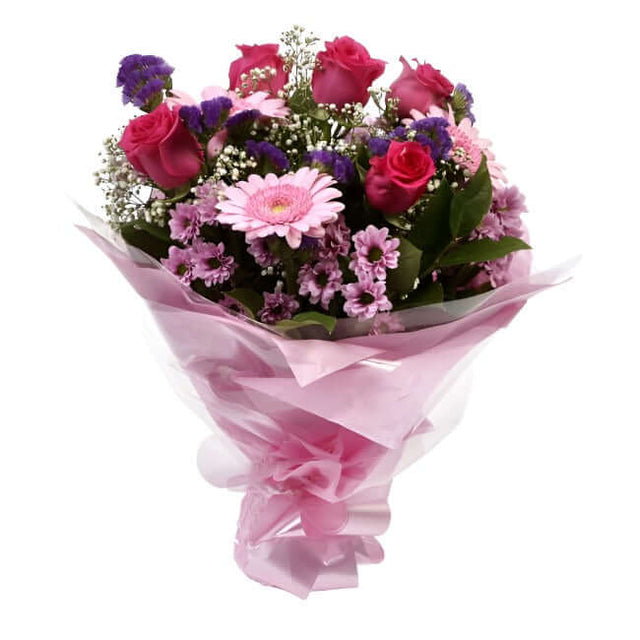 Pink Classic BouquetAn endearing classic in soft Pink with deep pink accents. Exquisite large headed Roses are complemented by Palm & delicate Pink Gypsophila, luxurious green foliage Pink Statice, to create a sophisticated hand-tied bouquet certain to im