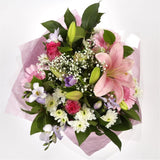 Pink Radiance BouquetAn endearing classic Lilies in soft pinks and whites with purple Freesias, large exquisite headed Anastasias, Pink Roses are complemented by delicate pink Gypsophila, luxurious sophisticated hand-tied bouquet certain to impress. Beaut