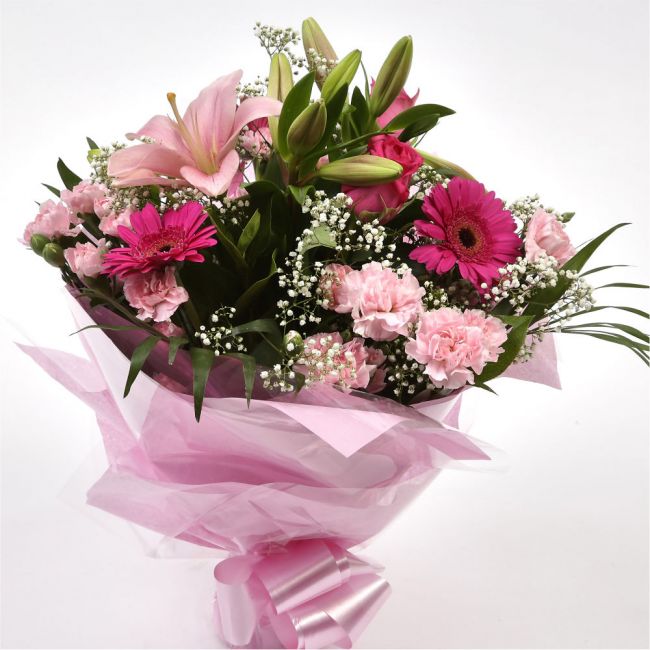 Pink Sienna BouquetThis lovely selection of flowers is the perfect gift for any occasion.Pink Germini, Pink Roses & Pink Spray with Palm Leaf and other assorted flowers are beautifully presented. Beautifully wrapped and tied with ribbon before being deliv