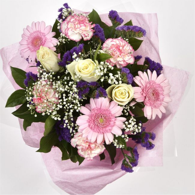 Pink Summer ChickThis Sweet Pink bouquet features matching pink Gerberas, Pink White Carnations, purple Statice and Pink Gypsophila, punctuated with White Roses. Expertly created by our florists Beautifully wrapped and tied with ribbon before being delive