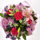 Stunning Pink Cerise BouquetThis Sweet Pink bouquet features matching Pink Chrysanthemums, Pink Cerise Carnations, purple Statice and Gypsophila, punctuated with leaves Pink Lillies, expertly created by our florists. Beautifully wrapped and tied with ribb