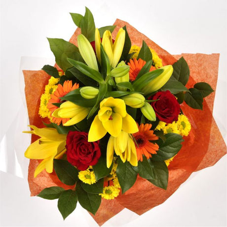 Orange Sunshine BouquetThis Sunshine bouquet features matching Red Roses.Orange Gerberas, Red Carnations, Lillie's with Solidago and other assorted flowers, punctuated with palm leaves expertly created by our florists.Beautifully wrapped and tied with rib