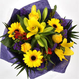Yellow Blush BouquetAn alluring hand-tied bouquet featuring Oriental Lilies, Gerberas, , White Roses, Anastasia in an array of pinks with striking Bloom Chrysanthemums and Pink Gypsophila. A truly glamorous gift for any special occasion. Expertly created