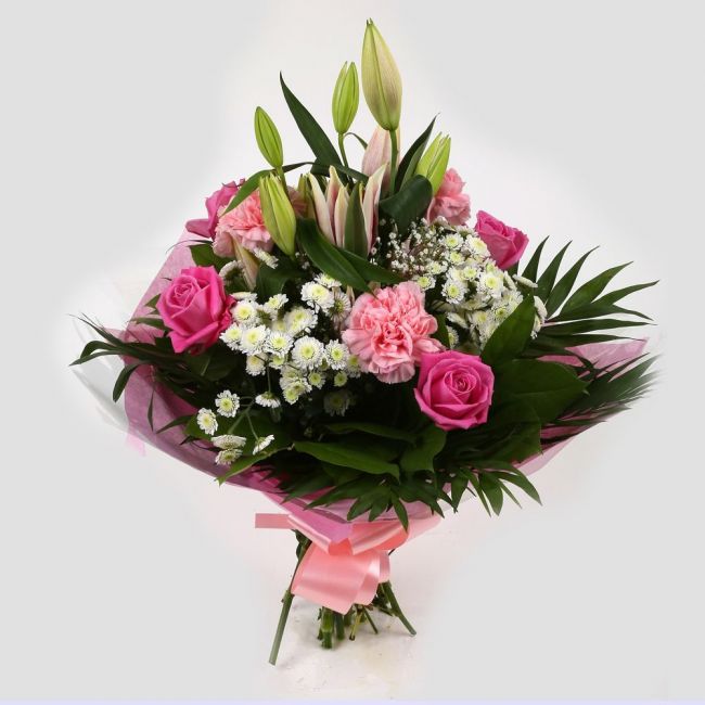 Strawberry Sundae BouquetStrawberry Sundae Bouquet, An endearing classic Bouquet, Lilies in soft pinks, White Santini, with Pink Roses, large exquisite headed Dianthus, Pink Roses are complemented by delicate Gypsophila, luxurious sophisticated hand-tied